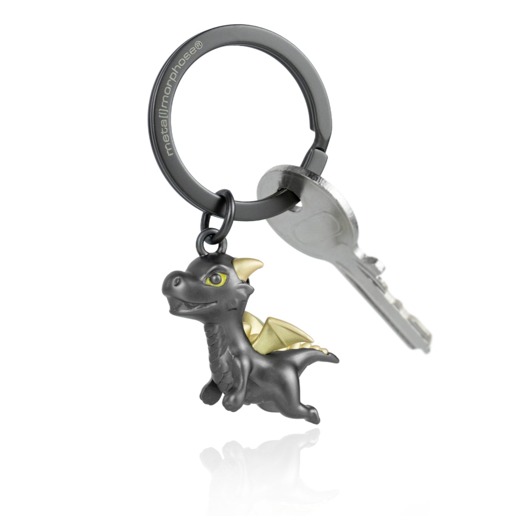 Keychain with dragon charm attached to a key on a white background
